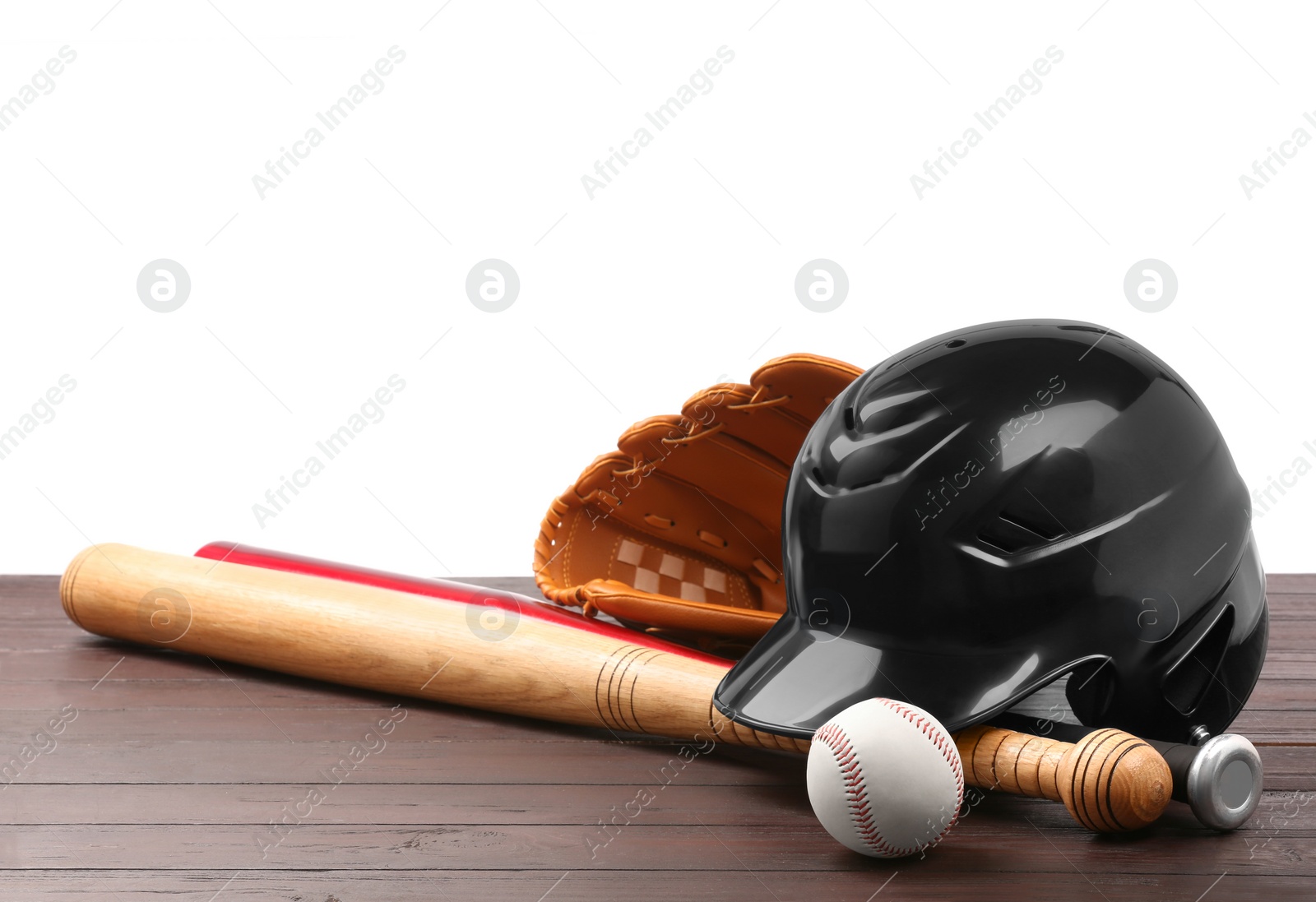 Photo of Baseball glove, bats, ball and batting helmet on wooden table against white background