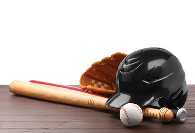 Baseball glove, bats, ball and batting helmet on wooden table against white background