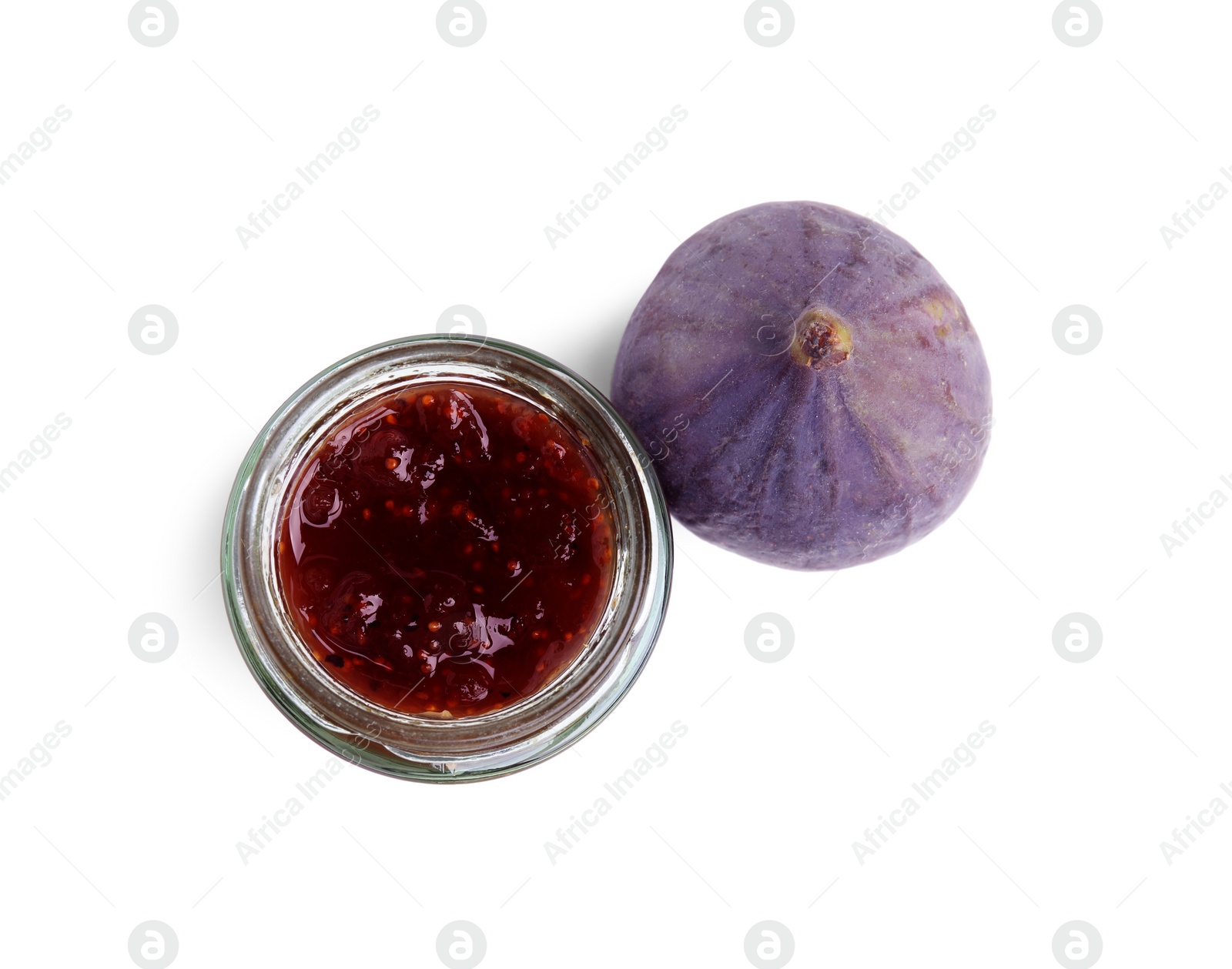 Photo of Glass jar of tasty sweet fig jam isolated on white, top view