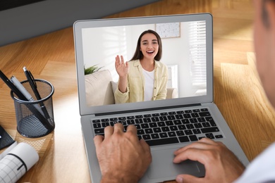 Coworkers working together online. Man using video chat on laptop, closeup