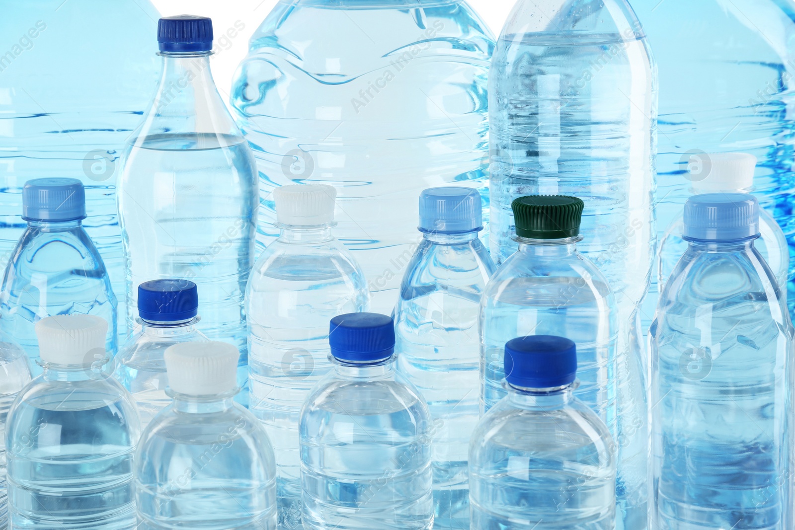 Photo of Set of different plastic bottles with pure water, closeup