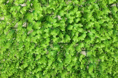 Green artificial plants as background, top view