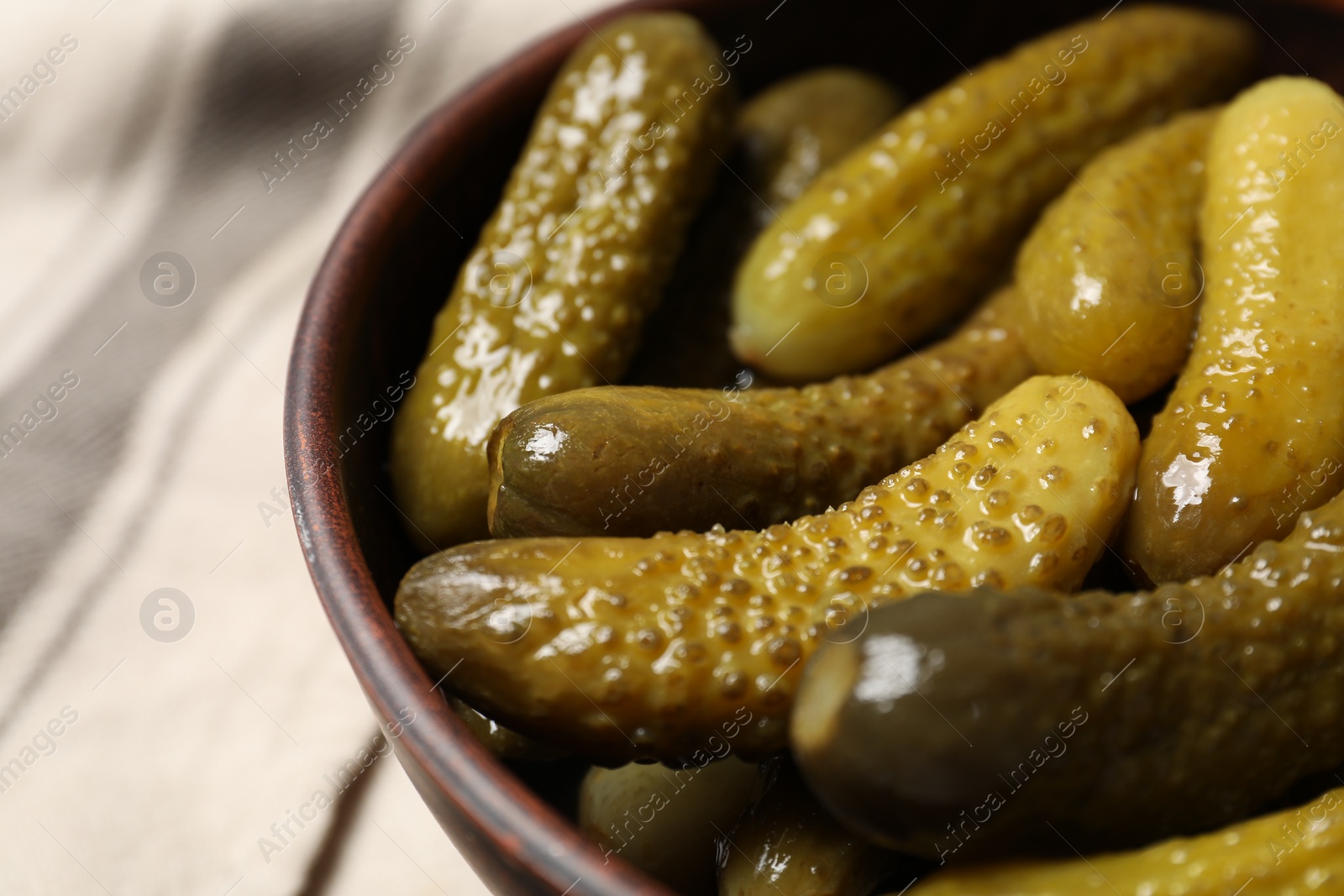 Photo of Tasty pickled cucumbers in bowl, closeup view