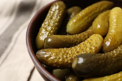 Tasty pickled cucumbers in bowl, closeup view