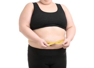 Photo of Overweight woman with measuring tape on white background