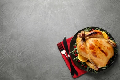 Photo of Delicious cooked turkey served on grey table, flat lay with space for text. Thanksgiving Day celebration
