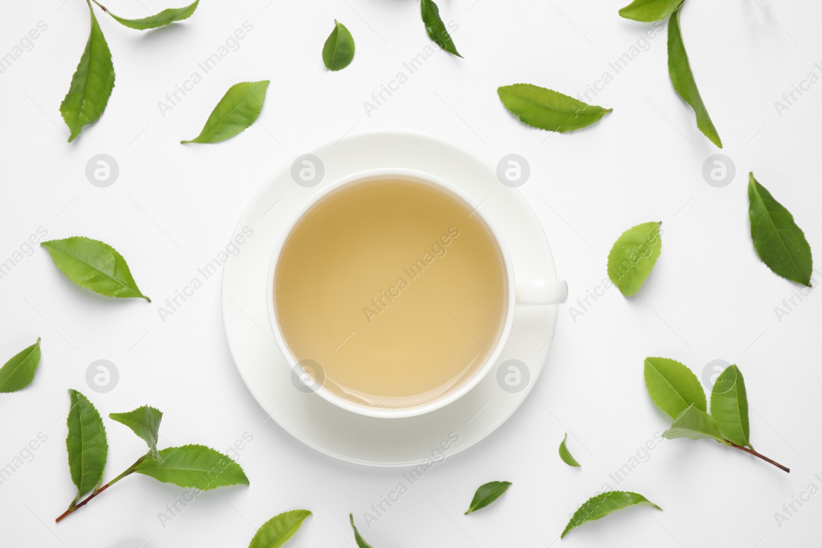 Photo of Flat lay composition with green tea on white background