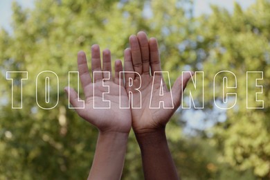 Image of Tolerance concept. Men of different races showing hands outdoors, closeup