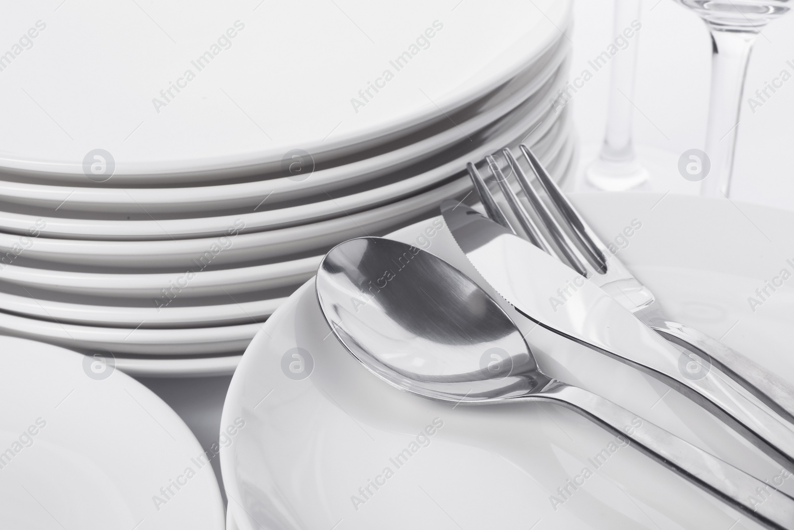 Photo of Set of clean tableware on white background, closeup. Washing dishes