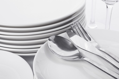 Photo of Set of clean tableware on white background, closeup. Washing dishes