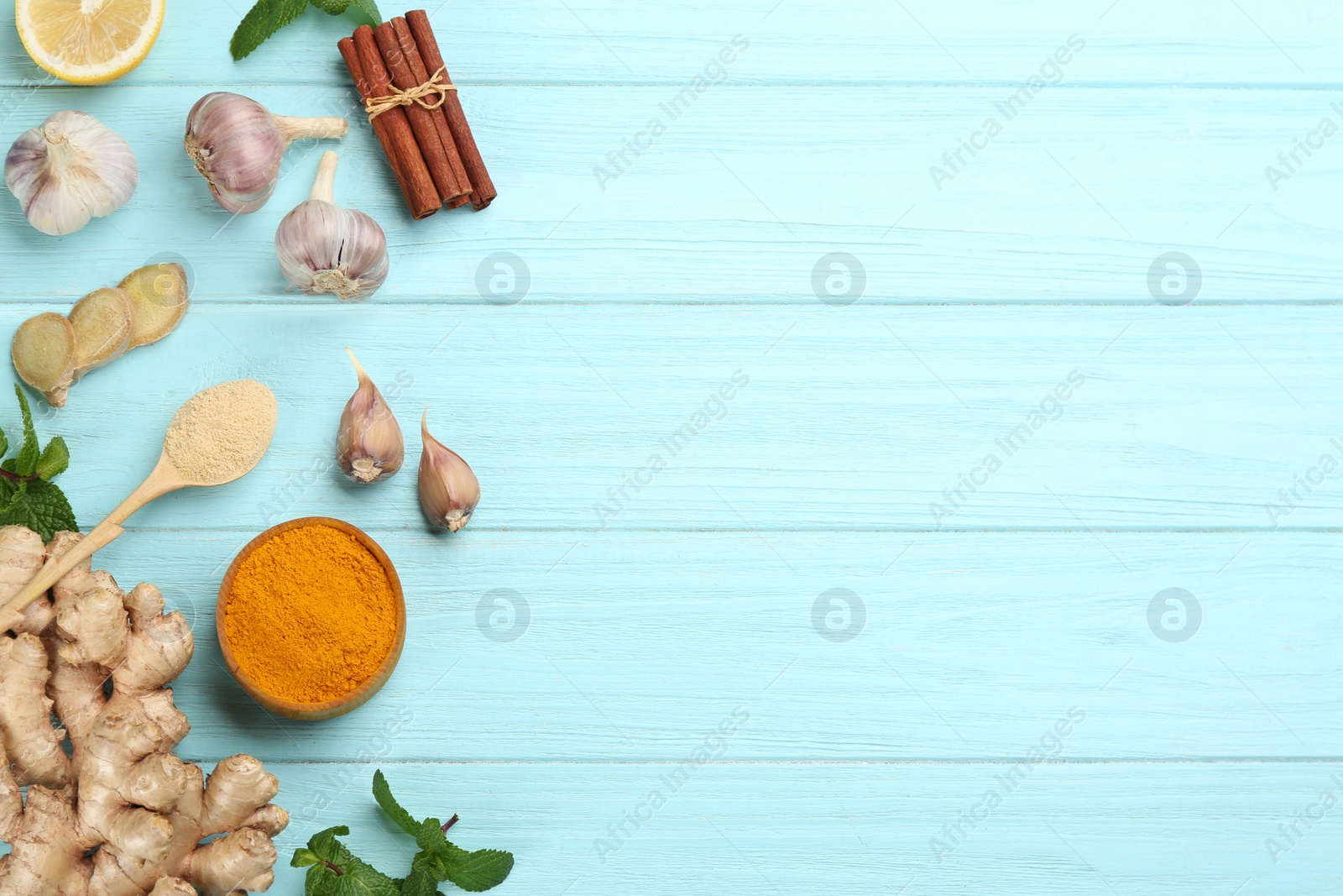 Photo of Flat lay composition with fresh products on light blue wooden background, space for text. Natural antibiotics