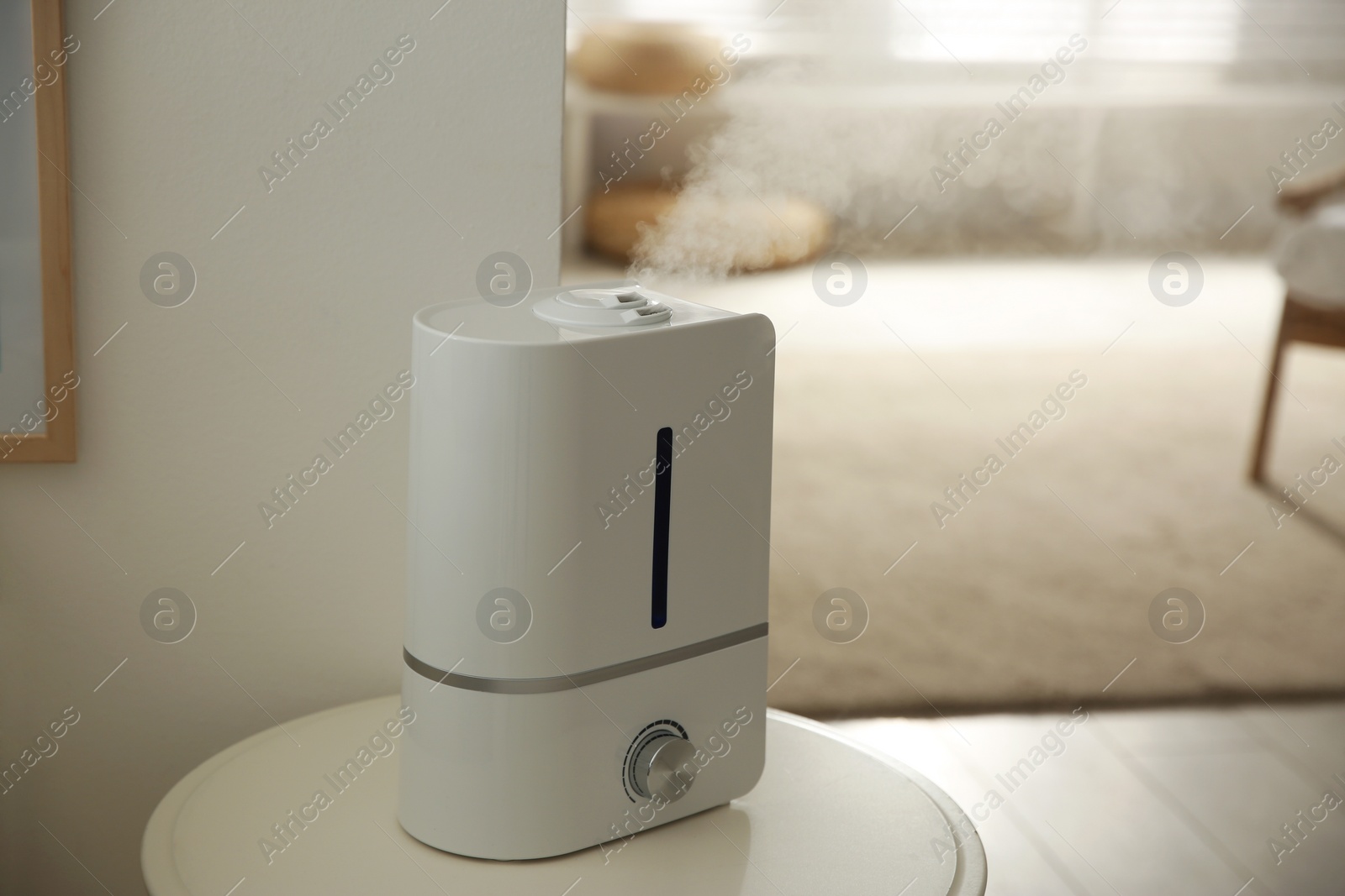 Photo of Modern humidifier on table indoors. Space for text