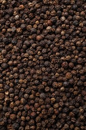 Photo of Aromatic black peppercorns as background, top view