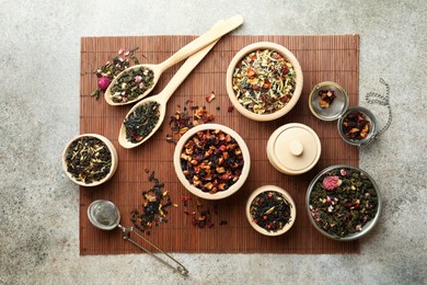 Photo of Many different herbal teas on grey table, flat lay