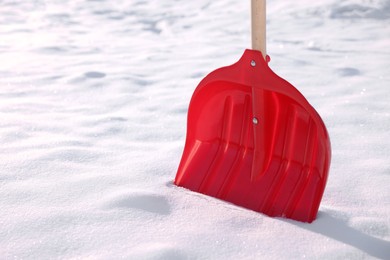 Snow shovel with wooden handle outdoors, closeup. Space for text