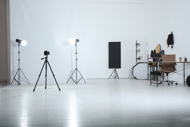 Photo of Photo studio interior with set of professional equipment and workplace