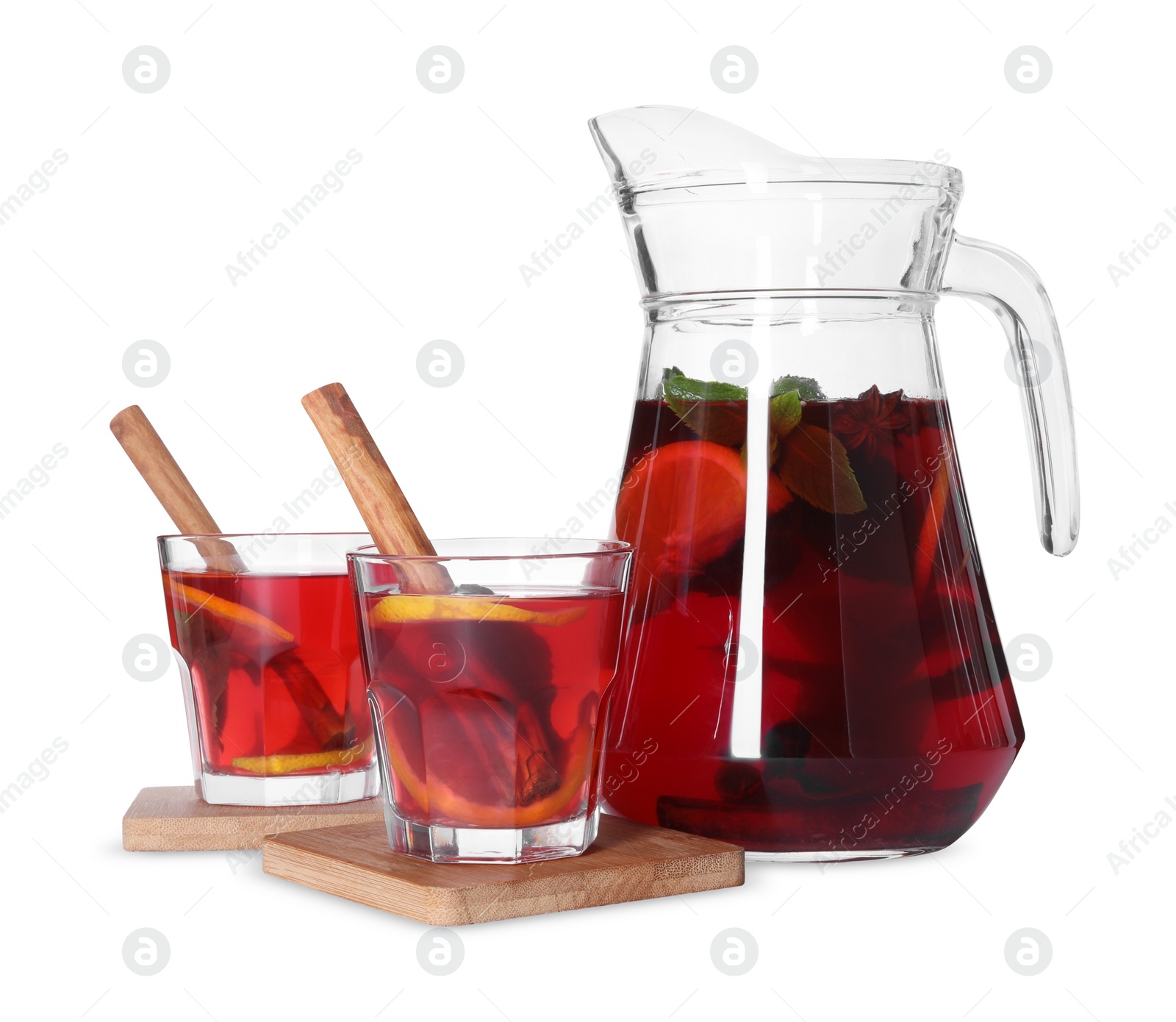 Photo of Jug and glasses with tasty punch drink isolated on white