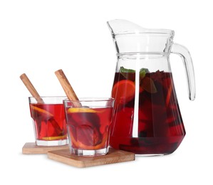 Photo of Jug and glasses with tasty punch drink isolated on white