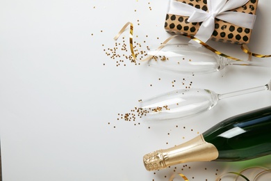 Photo of Creative flat lay composition with bottle of champagne and space for text on white background