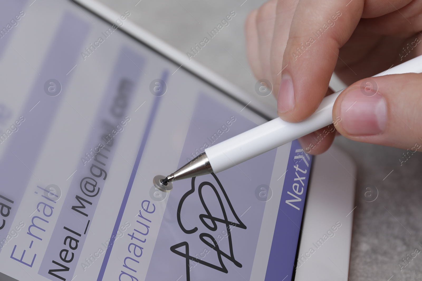 Image of Electronic signature. Man using stylus and tablet at table, closeup