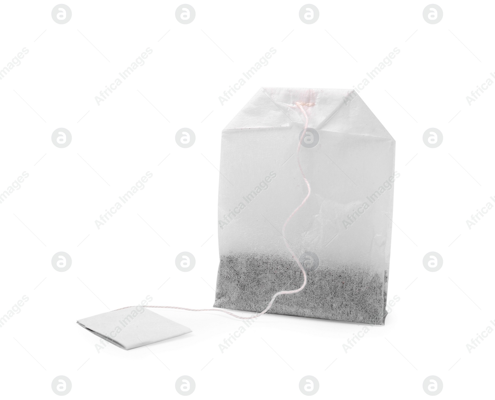 Photo of One new tea bag with label on white background