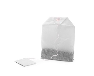 Photo of One new tea bag with label on white background