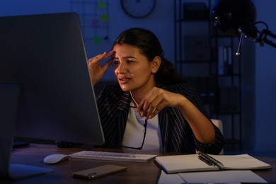 Photo of Tired businesswoman working at night in office