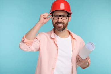 Photo of Architect in hard hat with draft on light blue background