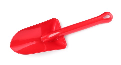 Photo of Red plastic toy shovel isolated on white, top view