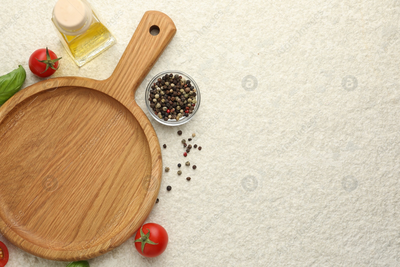 Photo of Cutting board, basil, oil, spices and tomatoes on white textured table, flat lay. Space for text