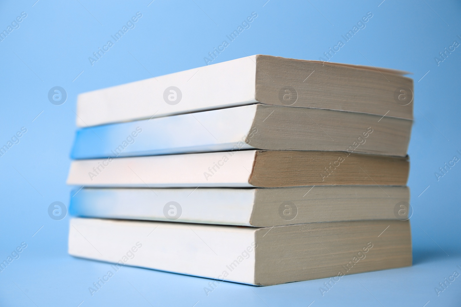 Photo of Collection of books on light blue background