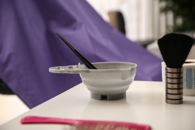 Photo of Workplace with bowl of hair dye in beauty salon