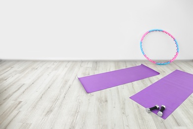 Hula hoop, yoga mats and dumbbells in physiotherapy gym