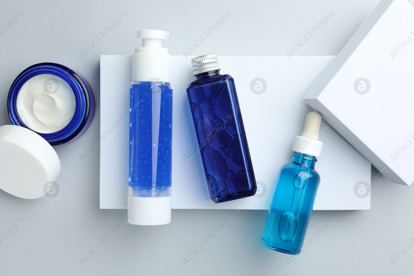 Photo of Set of cosmetic products on light grey background, flat lay
