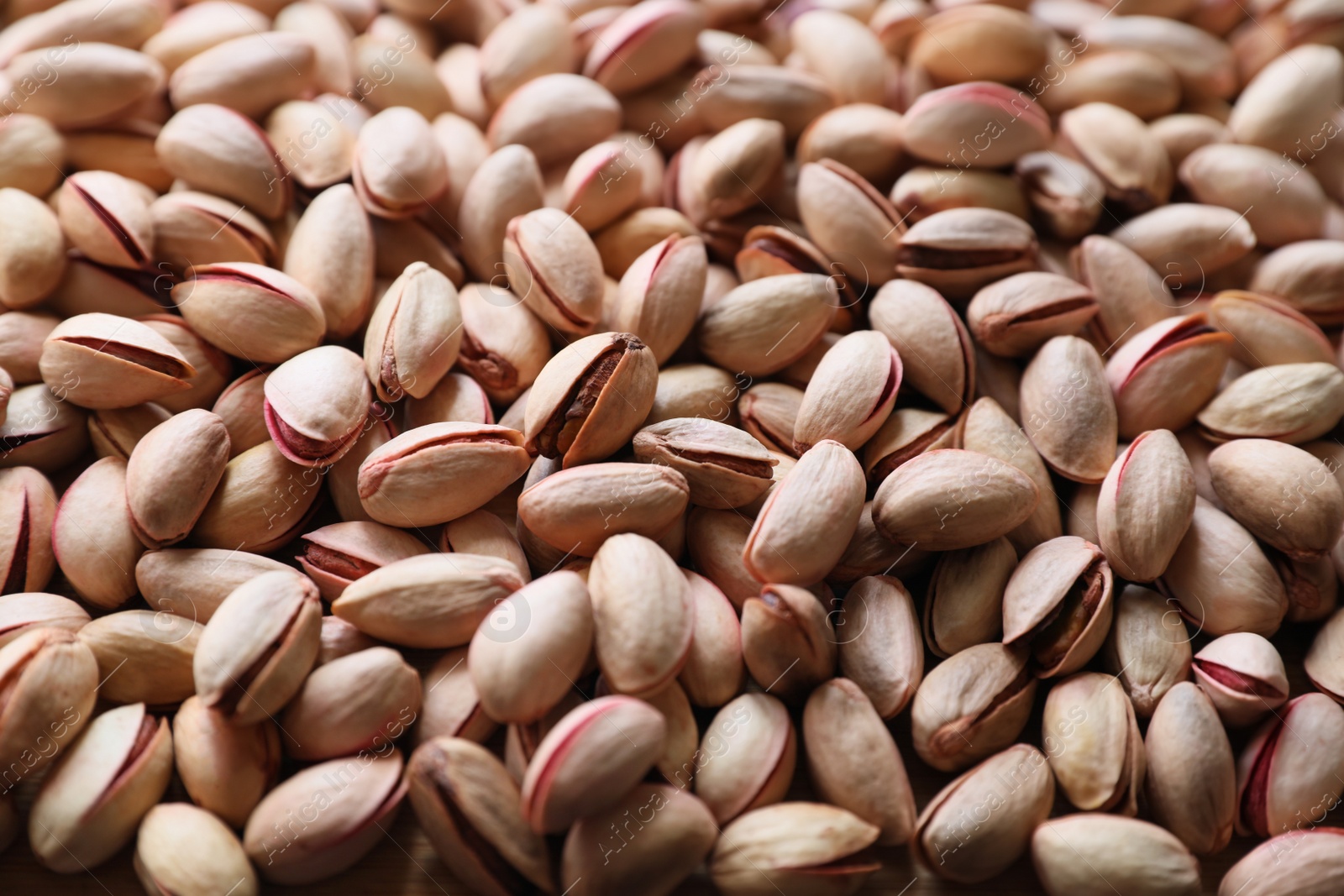Photo of Many tasty pistachios as background, closeup view