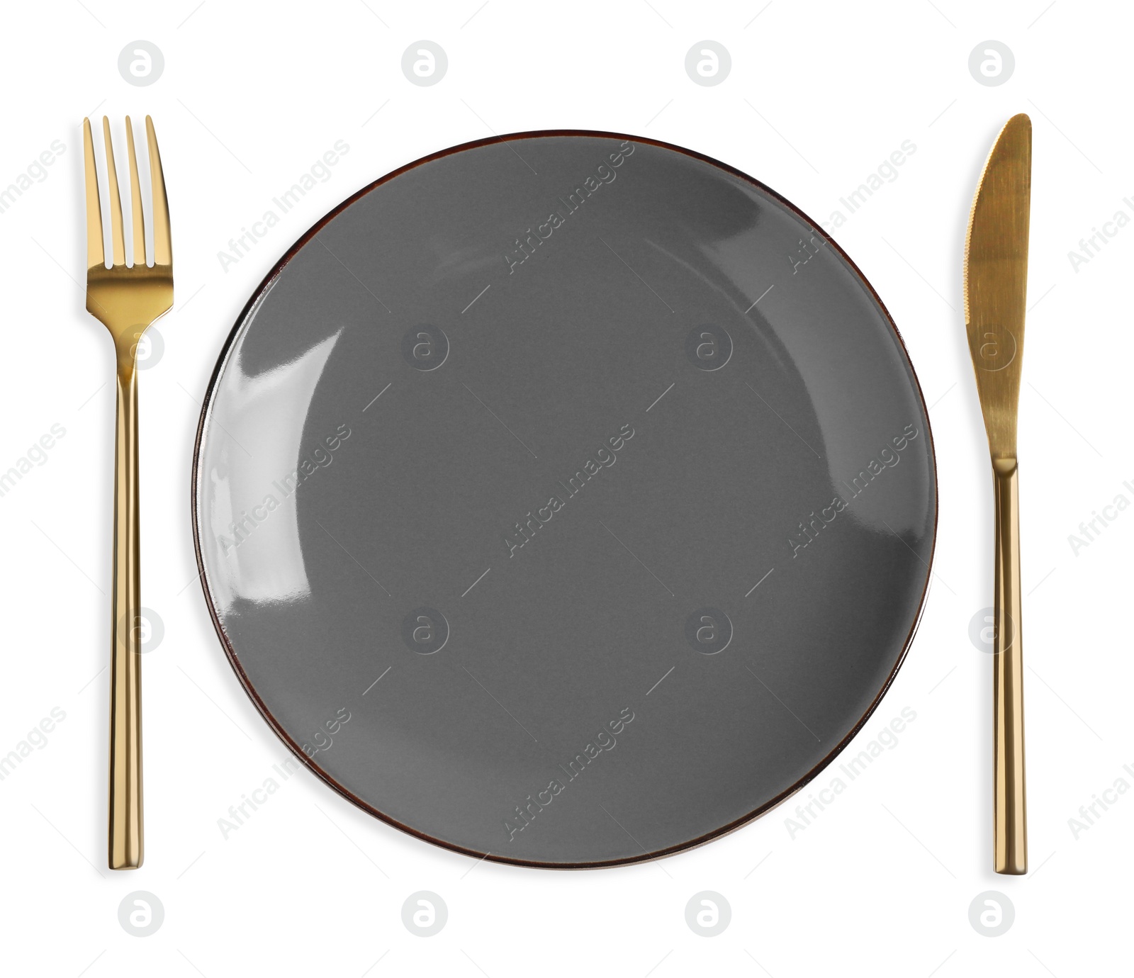 Photo of Empty plate, fork and knife on white background, top view