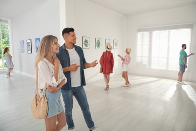 Photo of Happy couple at exhibition in art gallery