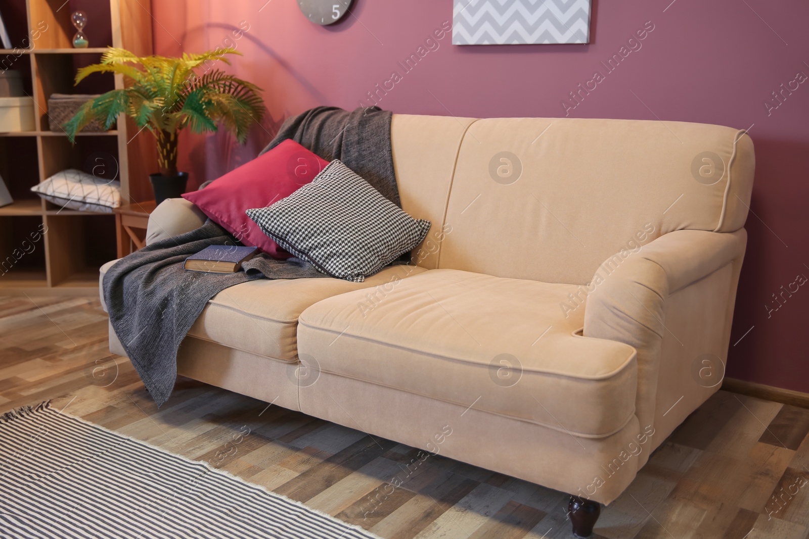 Photo of Elegant living room interior with comfortable sofa and swing chair