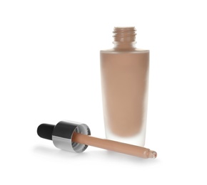 Photo of Bottle of skin foundation with pipette dispenser on white background