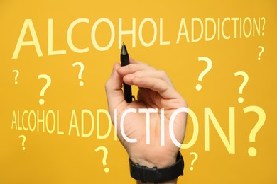 Image of Alcohol addiction? - We can help you. Closeup view of man with pen against yellow background