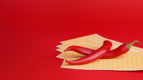 Pepper plasters and chili on red background, space for text. Alternative medicine