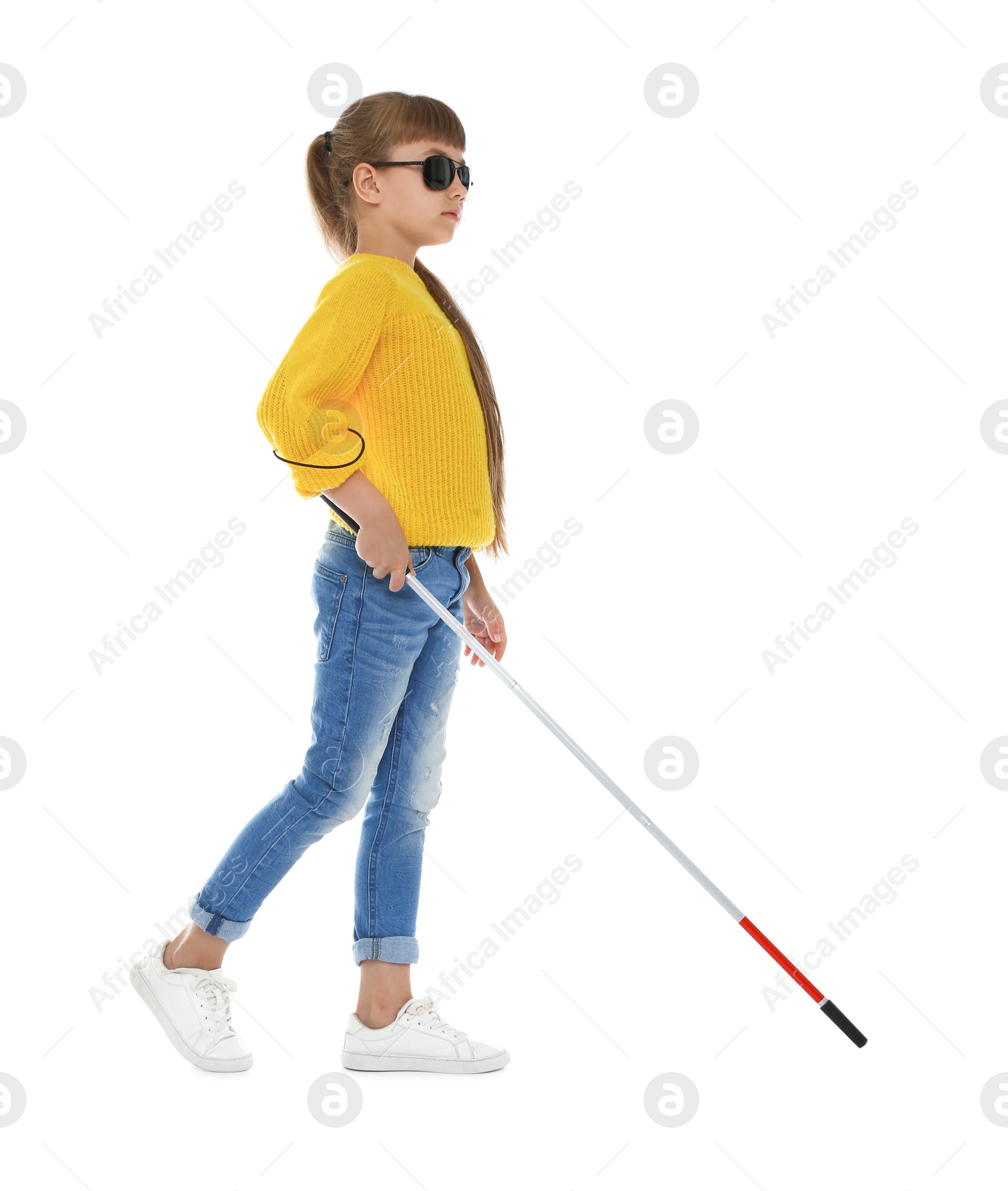 Photo of Blind girl with long cane walking on white background