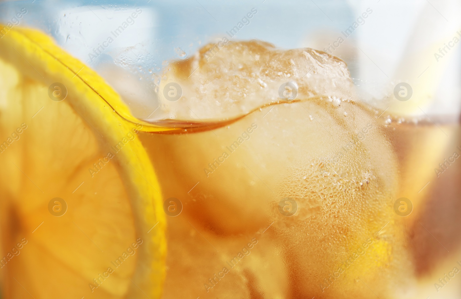Photo of Glass of lemonade with ice cubes, closeup