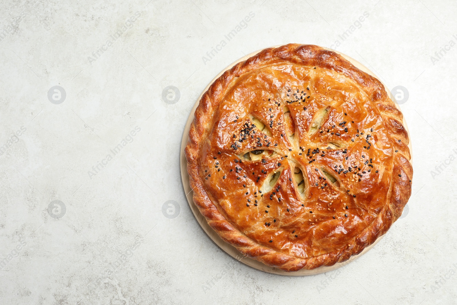 Photo of Tasty homemade pie with filling on light table, top view