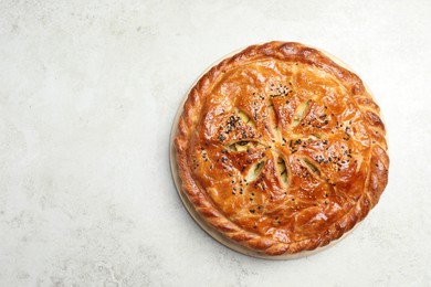 Tasty homemade pie with filling on light table, top view