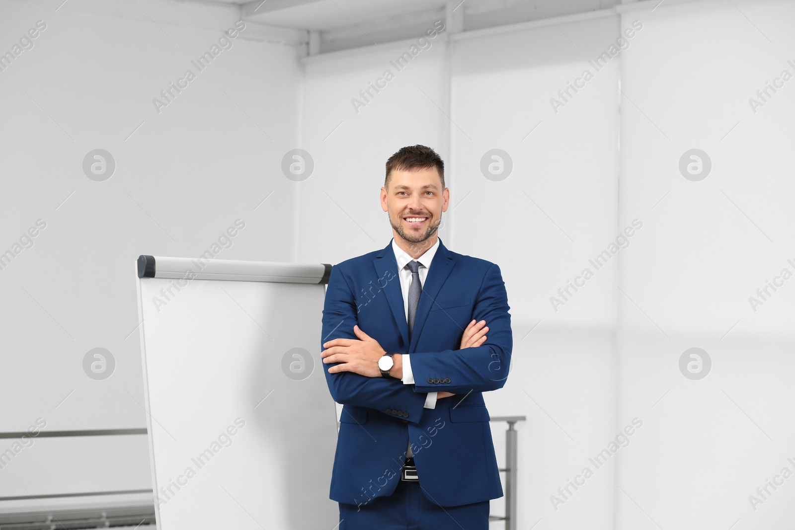 Photo of Professional business trainer near flip chart board indoors. Space for text