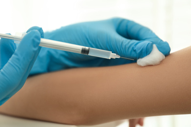 Photo of Doctor vaccinating little child in clinic, closeup