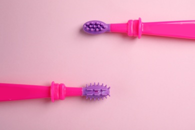 Manual toothbrushes for children on color background, top view