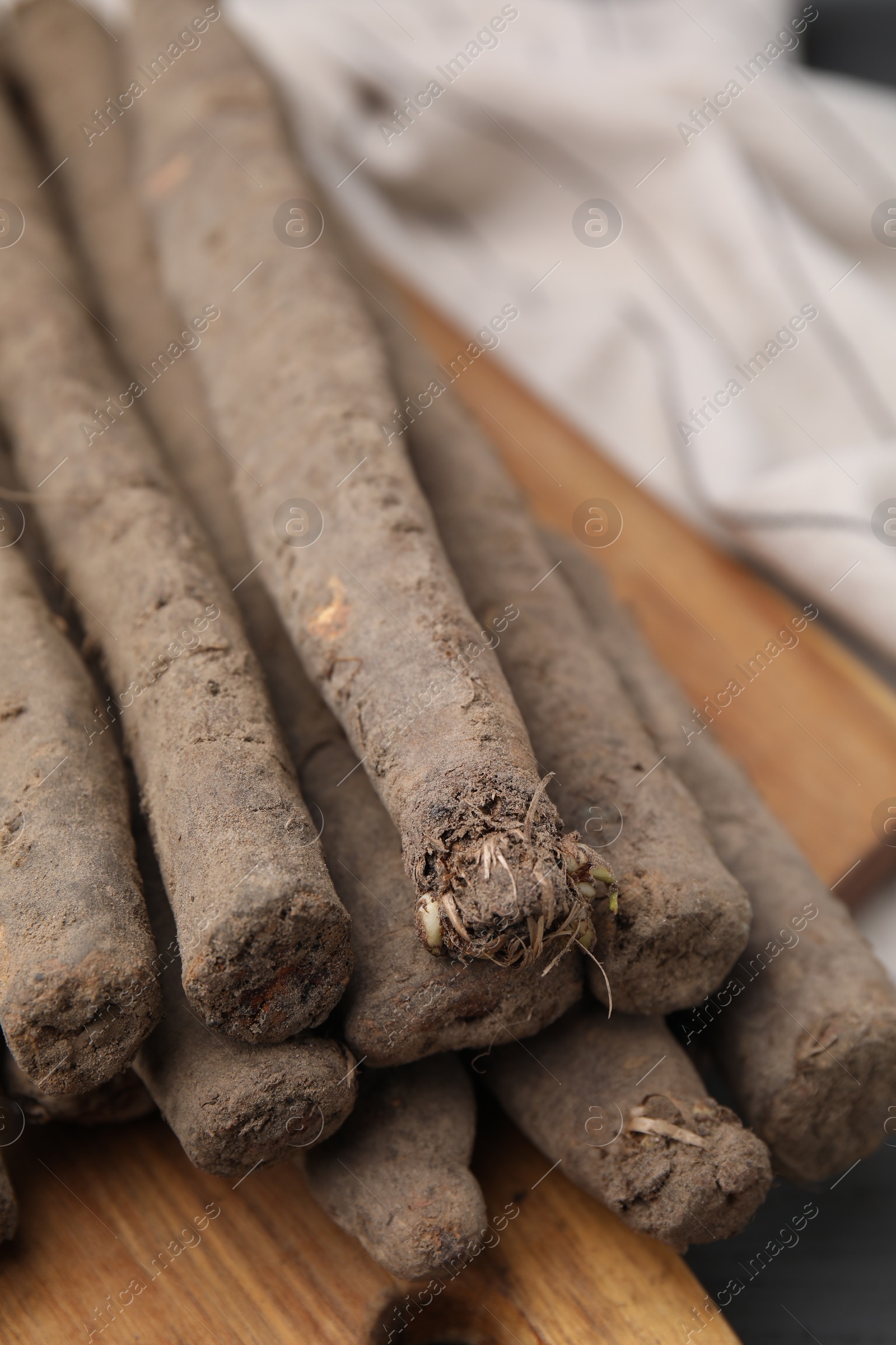 Photo of Fresh raw salsify roots on table, closeup