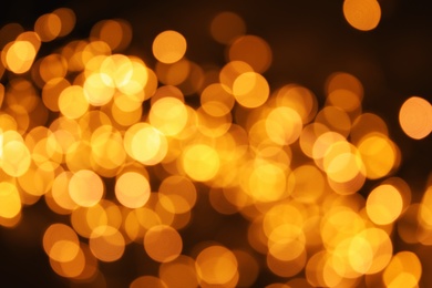 Photo of Gold glitter with bokeh effect on dark background